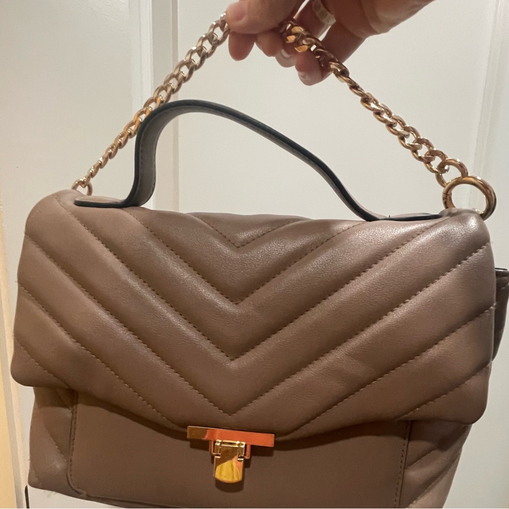 Taupe handbag with strap.